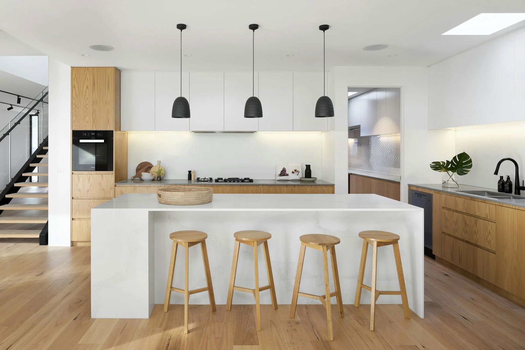 Bếp tối giản đảo đá và tủ gỗ liền mạch — kiến trúc bếp cao cấp cho kiến trúc sư